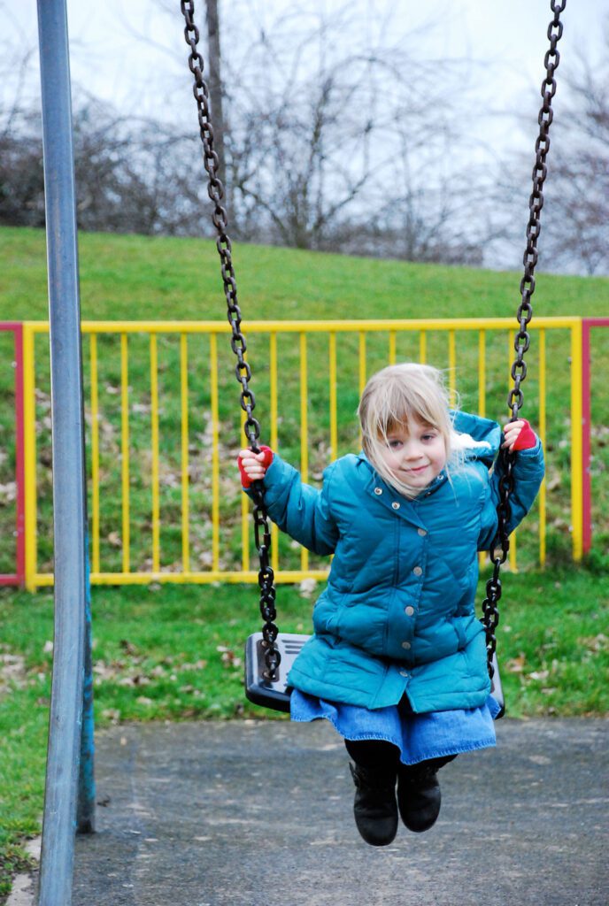 little girl on swing