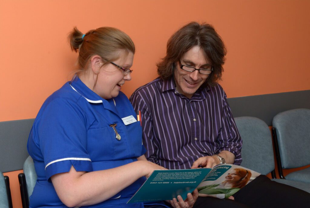 Emma and Patrick looking at leaflet